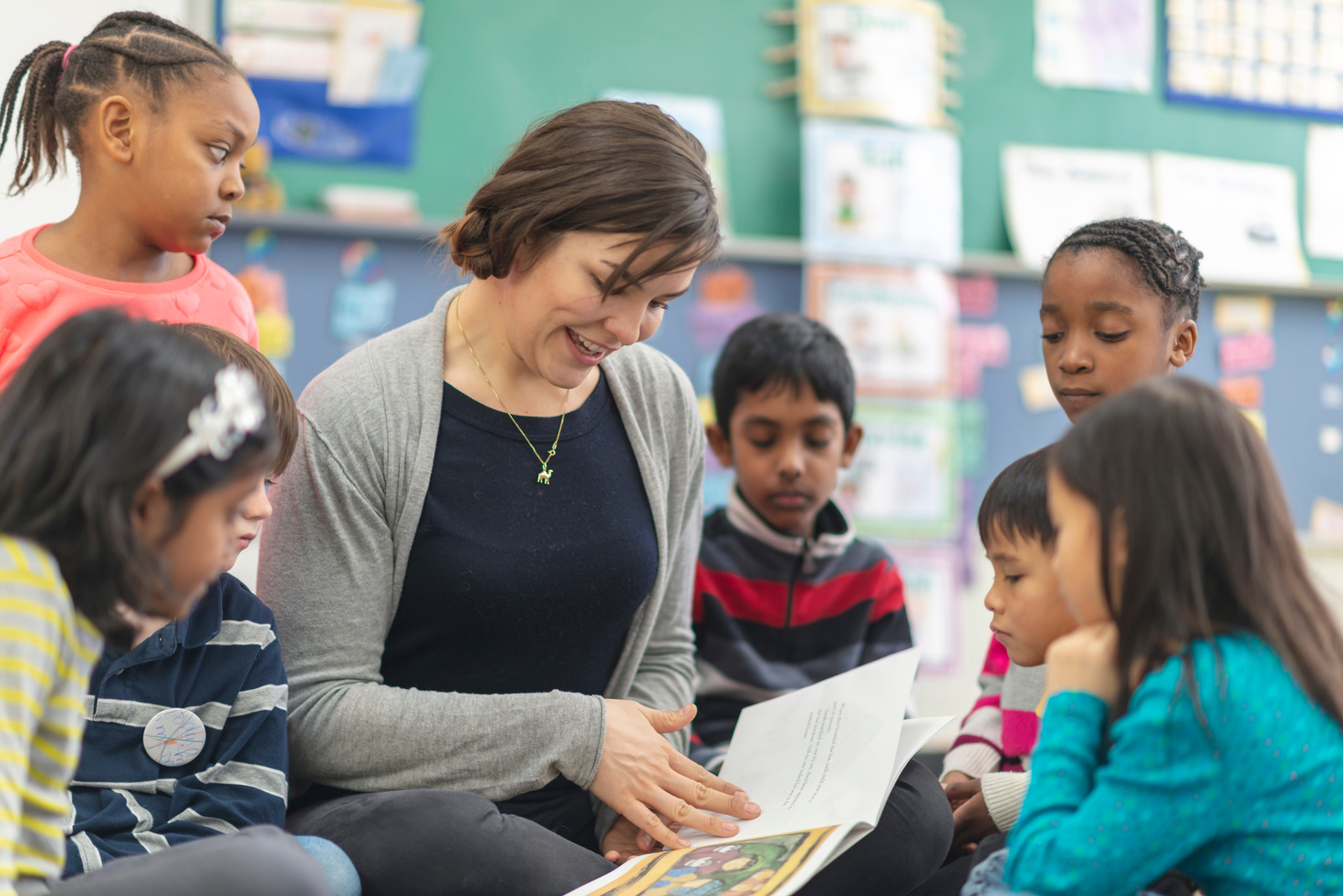 Teacher reading to elementary school students