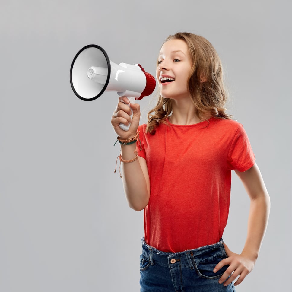 Happy Teenage Girl Speaking to Megaphone